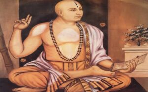 "Traditional portrait of Sri Madhvacharya sitting in a meditative posture, holding a palm-leaf manuscript (shastra) and showing the Chin-mudra, symbolizing divine knowledge and Dvaita philosophy.