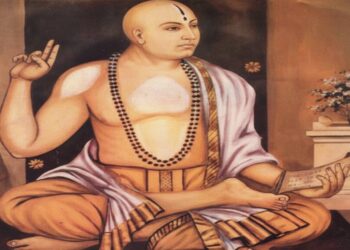 "Traditional portrait of Sri Madhvacharya sitting in a meditative posture, holding a palm-leaf manuscript (shastra) and showing the Chin-mudra, symbolizing divine knowledge and Dvaita philosophy.