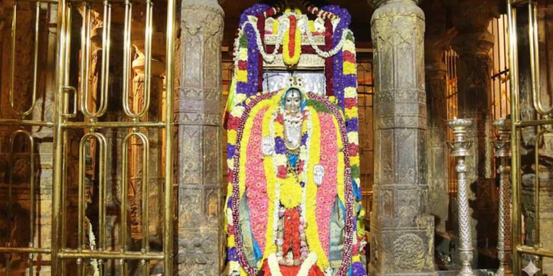 Sacred Brindavana of Sri Raghavendra Swamy at Mantralaya decorated with colorful flowers and traditional lamps.