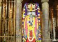 Sacred Brindavana of Sri Raghavendra Swamy at Mantralaya decorated with colorful flowers and traditional lamps.