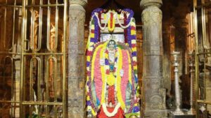 Sacred Brindavana of Sri Raghavendra Swamy at Mantralaya decorated with colorful flowers and traditional lamps.