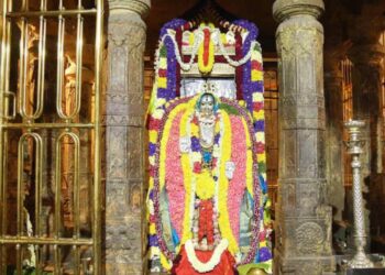 Sacred Brindavana of Sri Raghavendra Swamy at Mantralaya decorated with colorful flowers and traditional lamps.