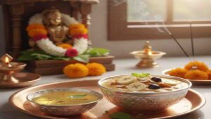 A decorative copper plate featuring a silver bowl of Panchamrita with sliced bananas and a bowl of holy Teertha with saffron and tulsi, placed in front of a Hindu deity idol.