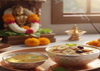 A decorative copper plate featuring a silver bowl of Panchamrita with sliced bananas and a bowl of holy Teertha with saffron and tulsi, placed in front of a Hindu deity idol.