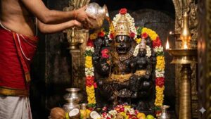 Divine AI-generated image of Lord Narasimha Swami idol being bathed with honey (Abhisheka) by a priest in a traditional temple setting with oil lamps and flowers.