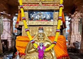 The sacred Moola Vrundavana of Sri Raghavendra Swamy in Mantralaya, adorned with a golden kavacha, flower garlands, and traditional offerings.