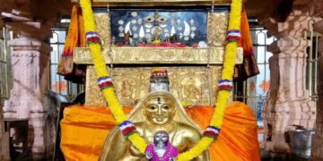The sacred Moola Vrundavana of Sri Raghavendra Swamy in Mantralaya, adorned with a golden kavacha, flower garlands, and traditional offerings.