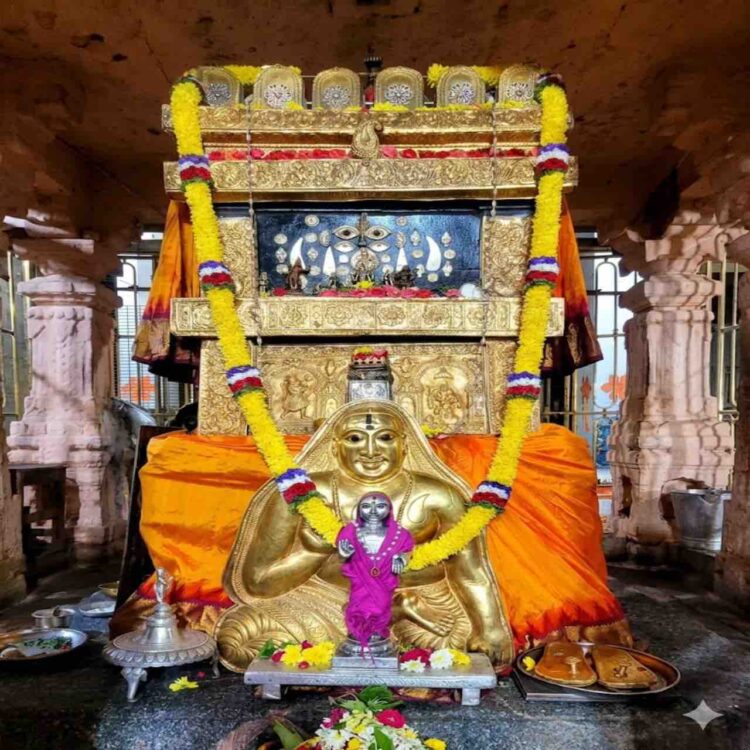 The sacred Moola Vrundavana of Sri Raghavendra Swamy in Mantralaya, adorned with a golden kavacha, flower garlands, and traditional offerings.