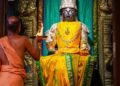 Idol of Lord Rogamochana Dhanvanthri at Uttaradi Math Mysore with a priest performing Aarti.