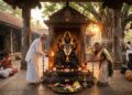 Traditional Shani Dev idol in a South Indian temple with devotees performing oil lamp rituals and offerings during Shanaischara Jayanti.