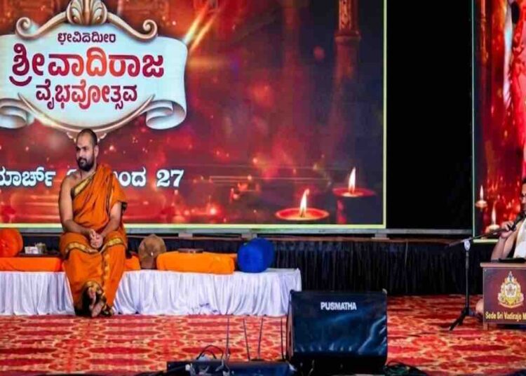 Sri Vishwavallabha Tirtha Swamiji of Sode Mutt and Dr. Prandeva Upadhyaya on stage at Vadiraja Vaibhavotsava in Hoovinakere.