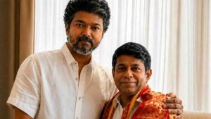 Actor Vijay posing with astrologer Radhan Pandit during an indoor meeting