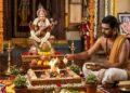 Hindu groom performing Gandharvaraja Homa with sacred fire and white flowers dipped in honey for early marriage.
