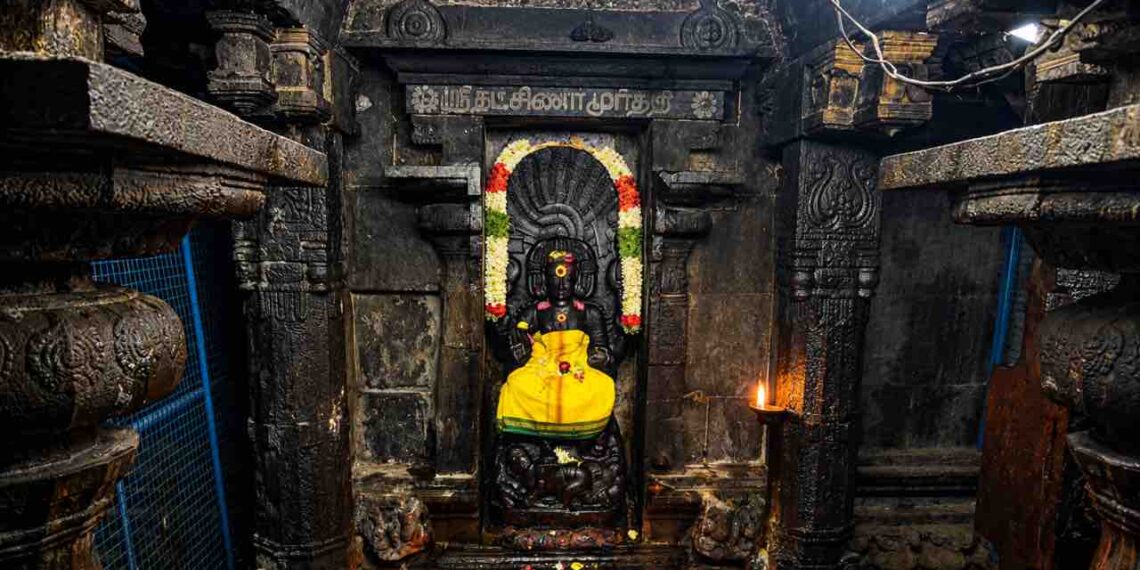 Sanctum of Sri Suddha Ratneswarar Temple at Oottathur, Tamil Nadu, featuring the sacred deity amidst ancient stone architecture and oil lamps.