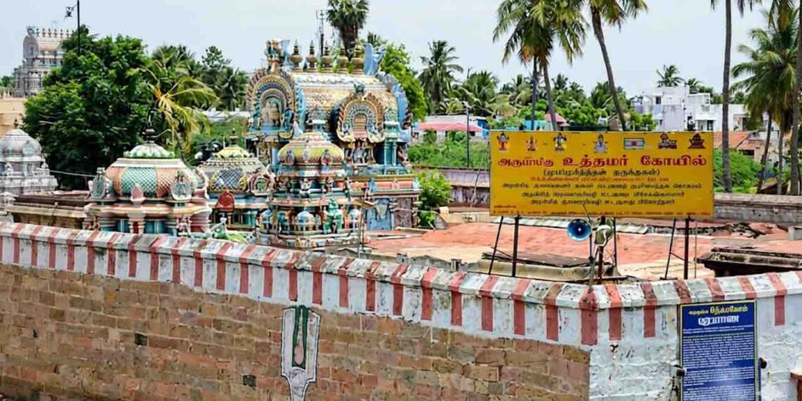 A detailed wide-angle photograph of the historic Uthamar Kovil temple complex near Tiruchirappalli, Tamil Nadu, showcasing several intricately decorated gopurams (temple towers) and mandapams.